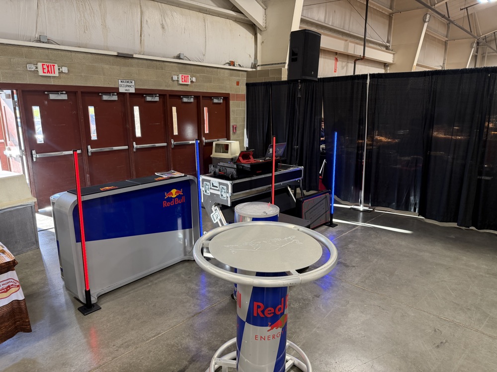 Branded bar and DJ booth under LED pillars